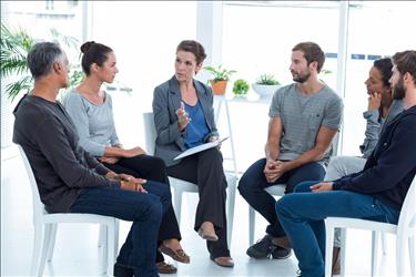 mental health professional leading a group therapy session