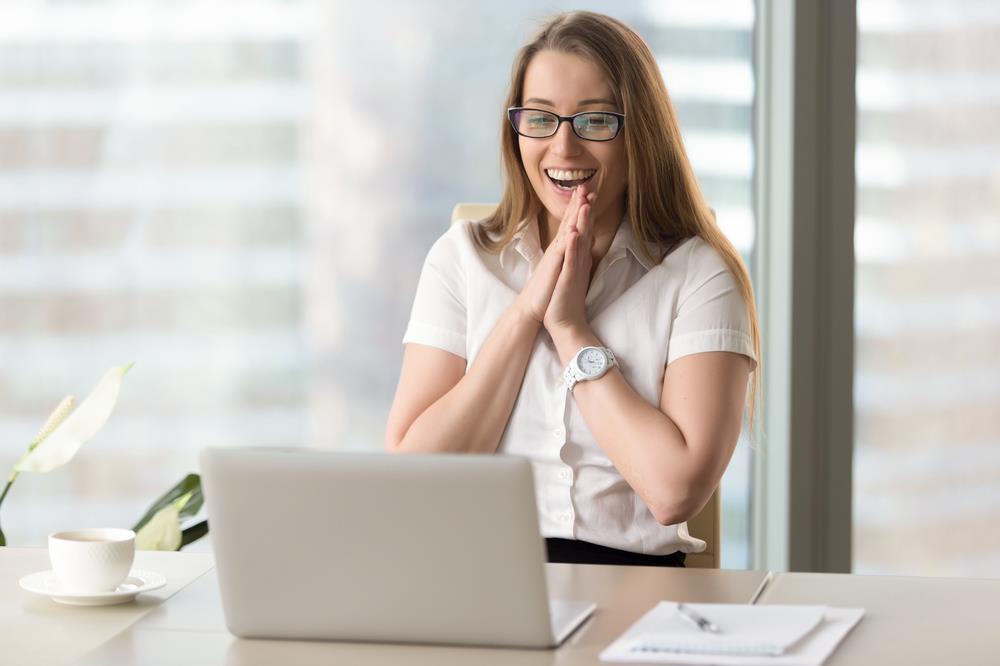 Young professional celebrating after receiving an official job offer email