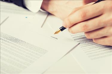 business person signing an official letter or contract