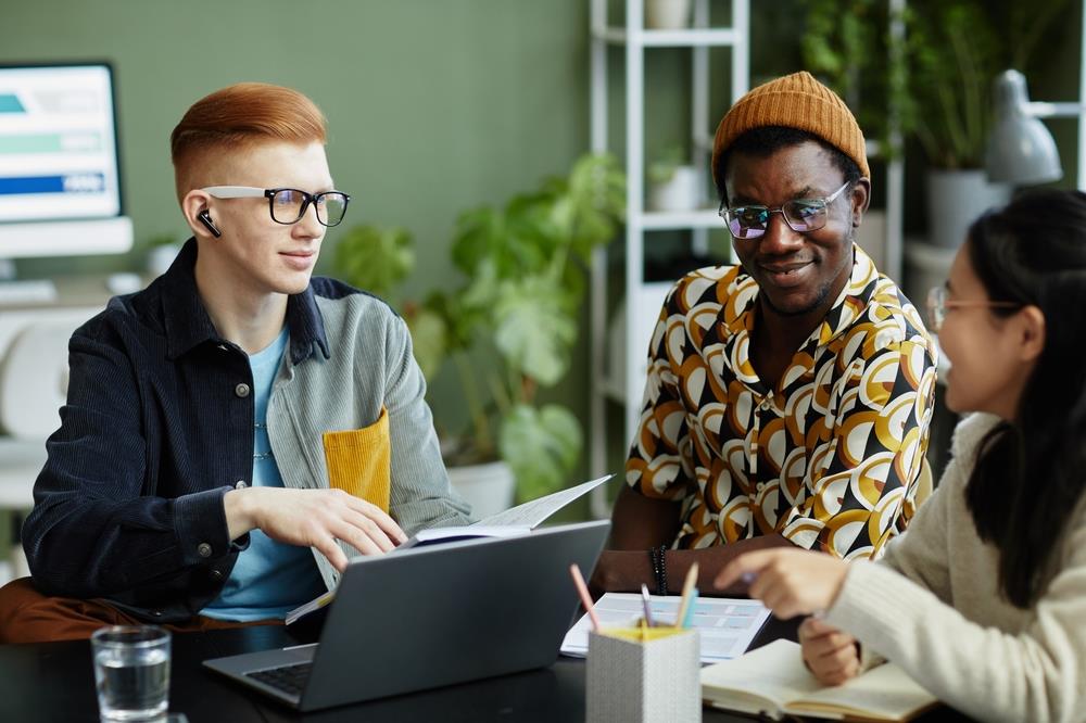 gen z employees working together at a table