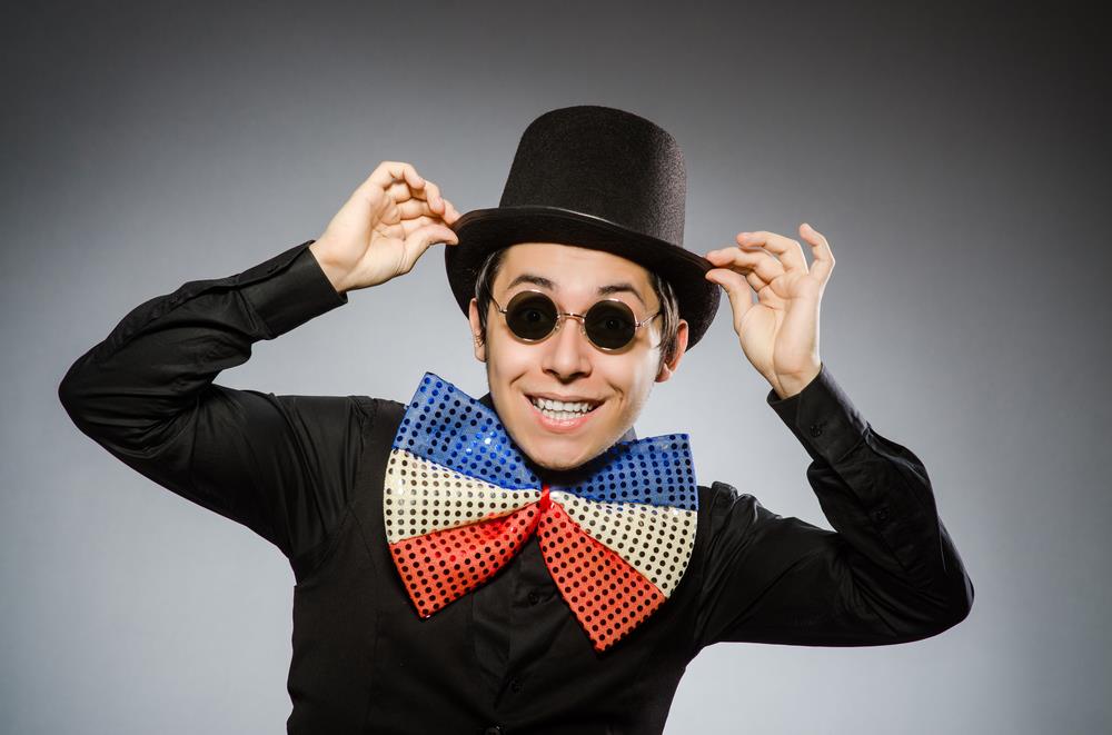 Silly job seeker is trying too hard to have a memorable brand, wearing a tacky bow tie, sunglasses, and a top hat.