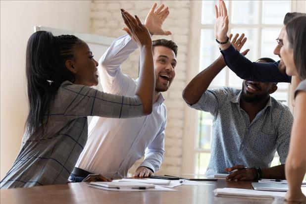 team members sharing a group high five to celebrate a team win