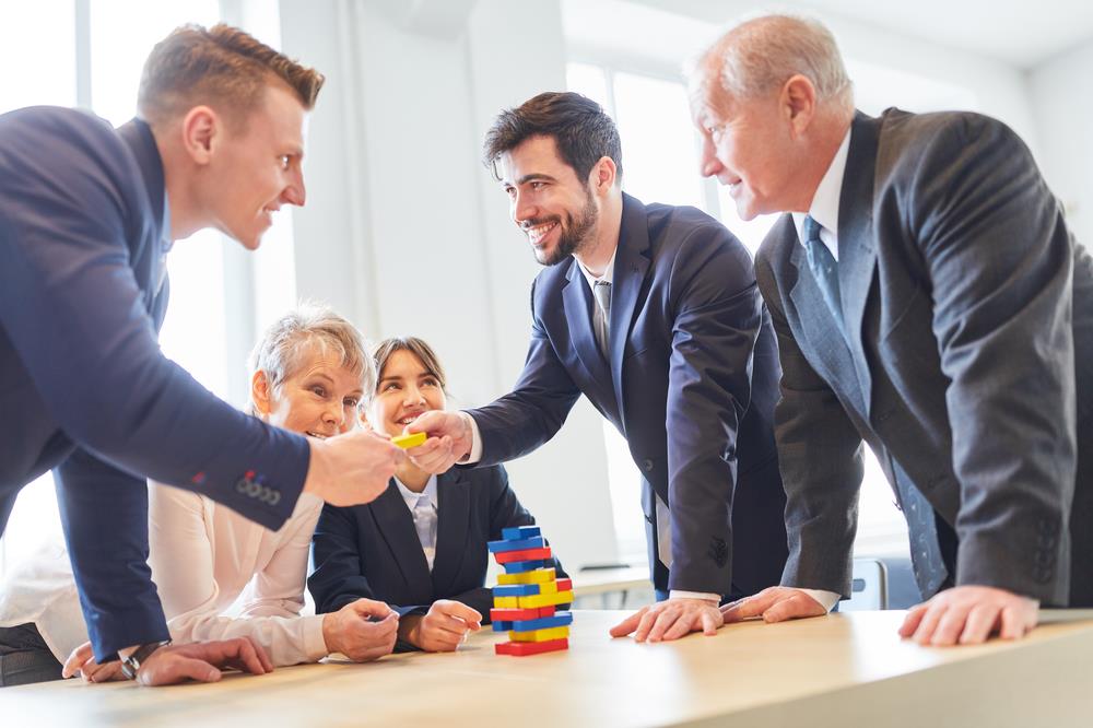 team members playing a board game as part of a team building activity