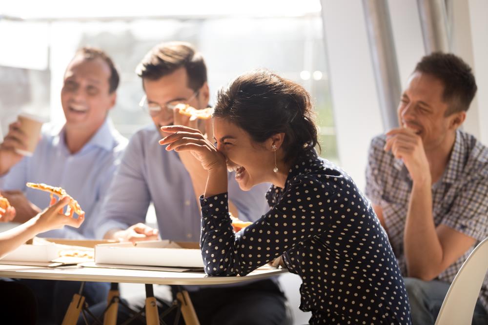 team members enjoying pizza together as part of a team building activity