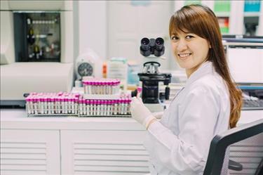 Medical technologist examining samples in the diagnostic lab.