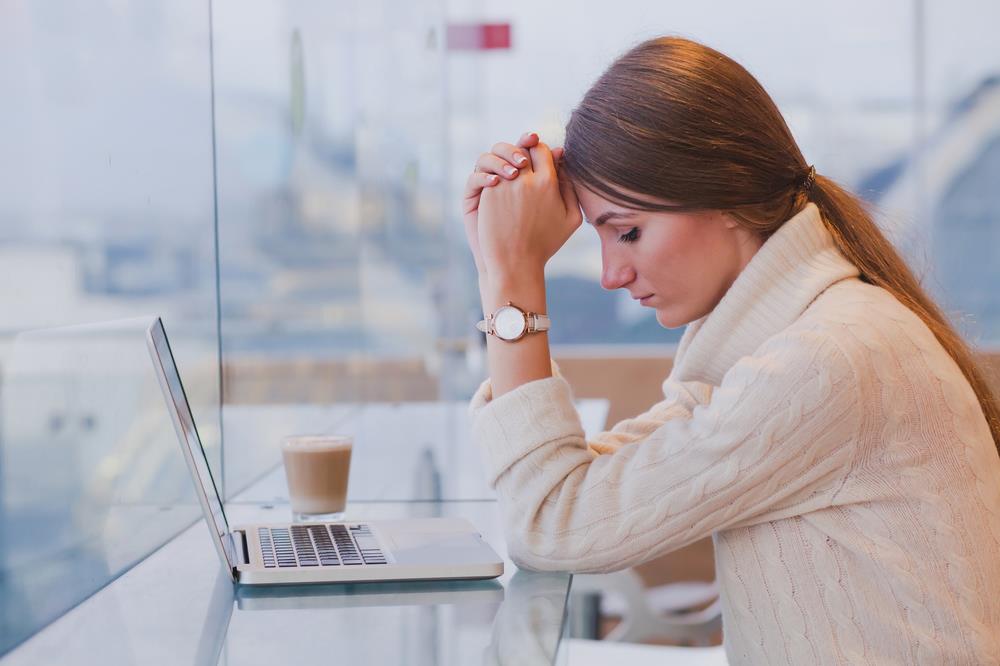 Job seeker waiting by the computer for an email. 