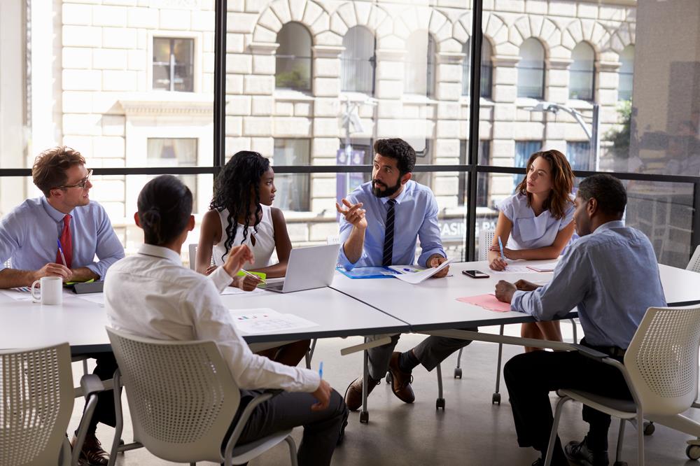 optometry professionals meeting in a small group at an optometry conference