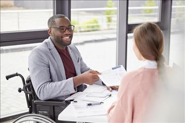 Man in wheelchair applying to job