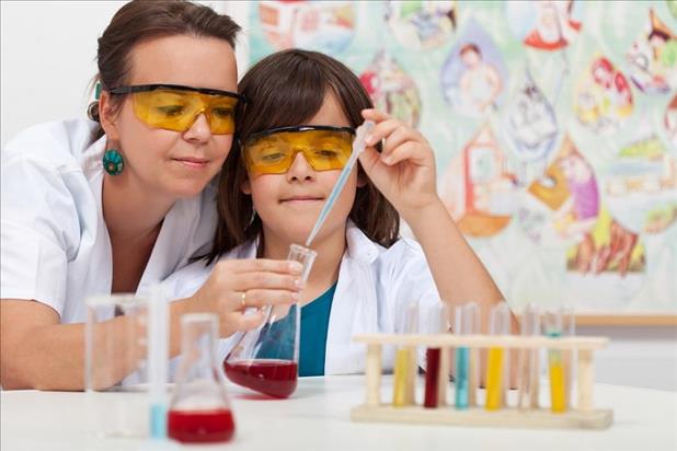 chemist volunteering in a classroom with young student