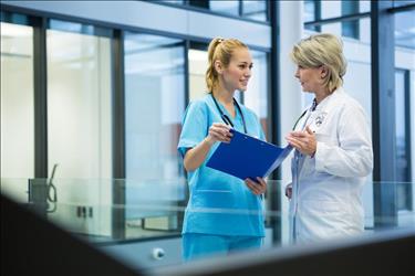 nurse practitioner discussing patient records with a physician