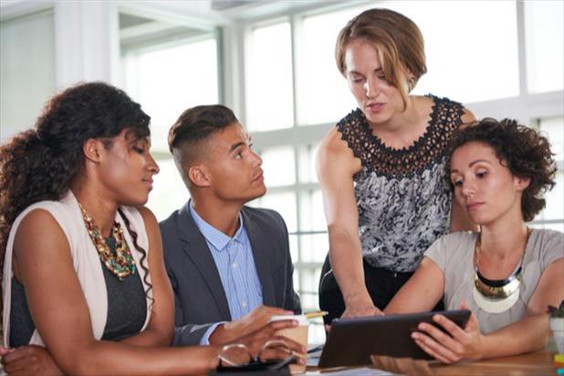 group of employees looking at computer