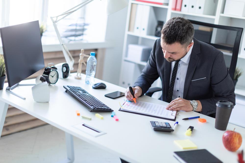 insurance agent reviewing client data at his desk