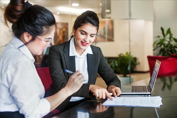 insurance agent going over paperwork with her client