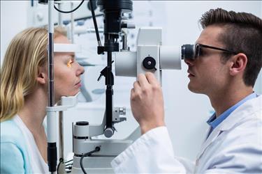 ophthalmic technician conducting a test on a patient