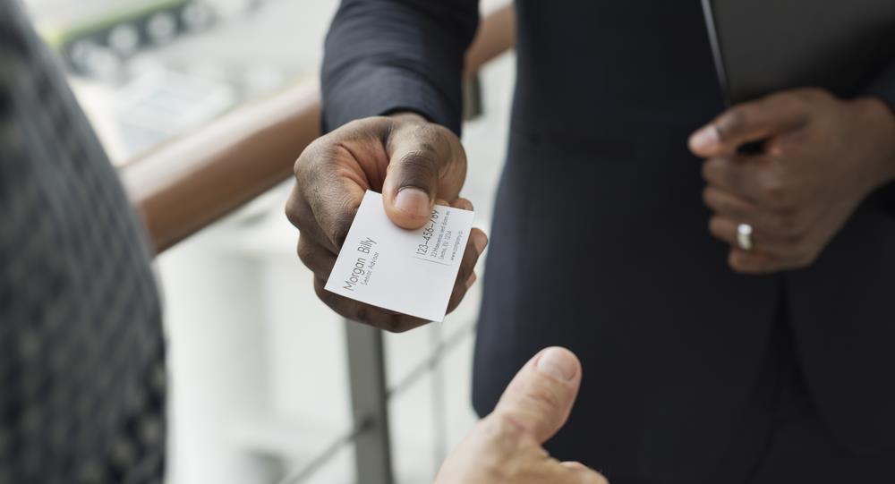 professional handing his business card to someone