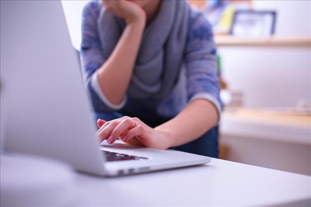 Closeup of woman sitting in front of a laptop