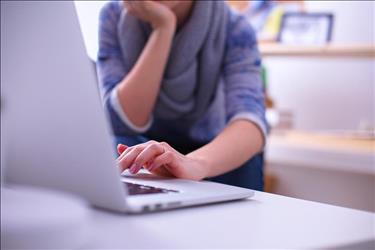 Closeup of woman sitting in front of a laptop