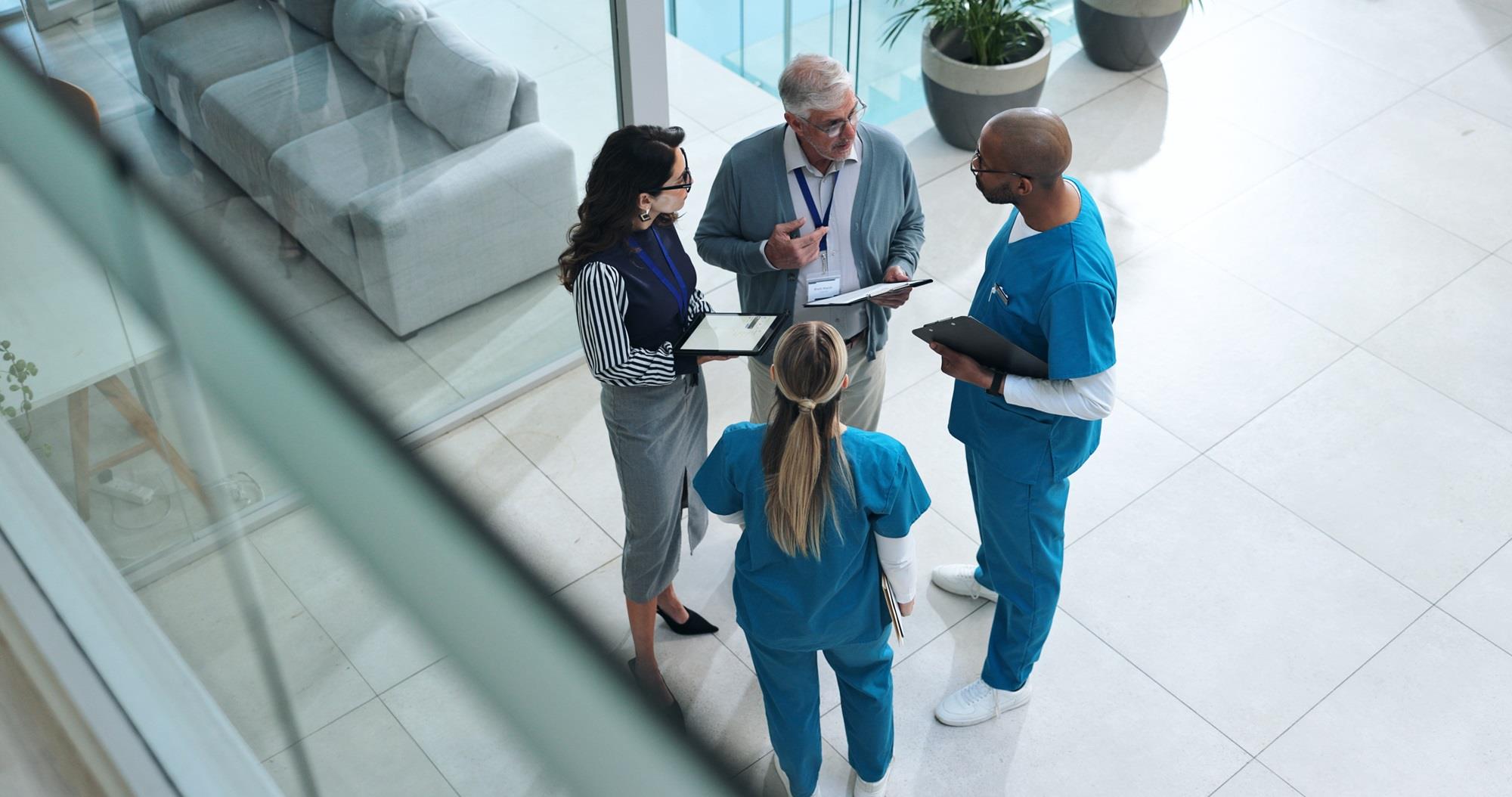 medical team meeting in a hospital lobby