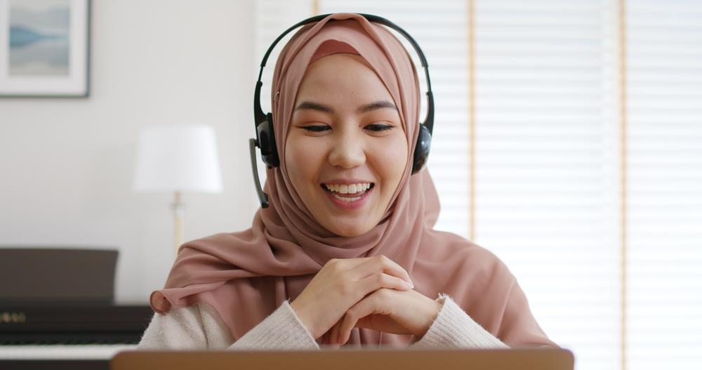 young job seeker wearing a hijab participating in a virtual interview