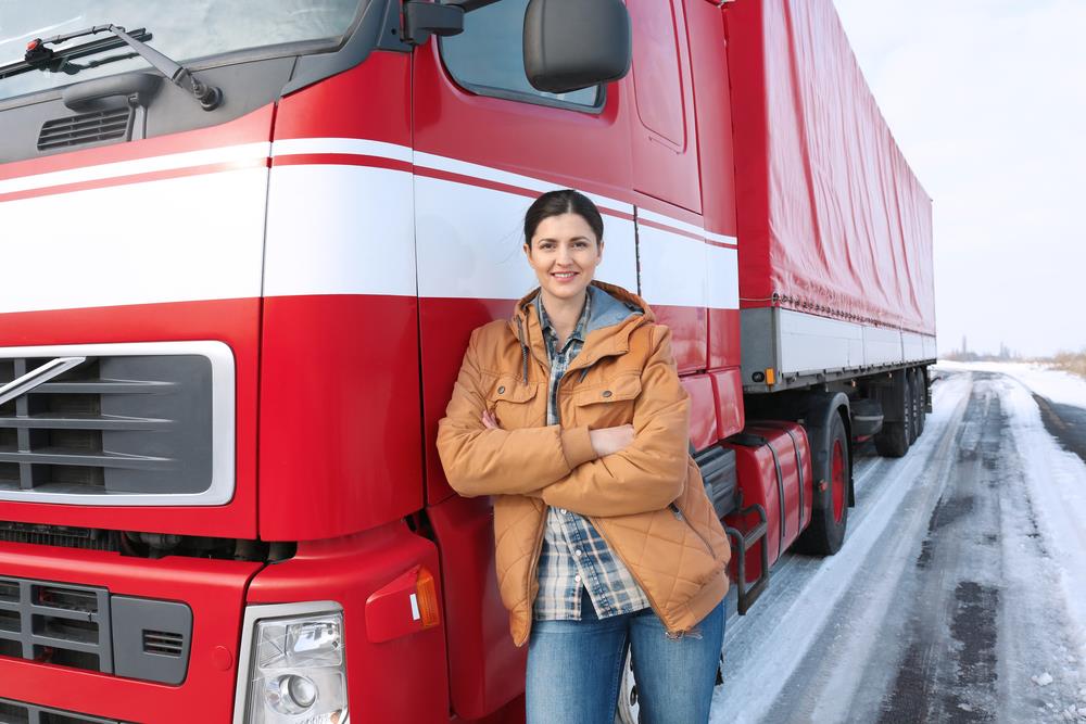 truck driver standing in front of her truck