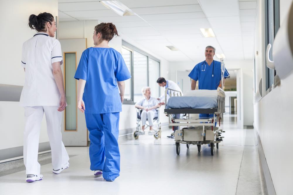 medical team of nurses and doctors walking down a hospital hallway