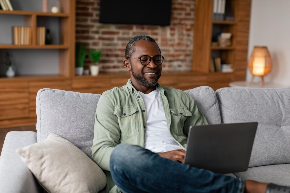 mature job seeker applying to jobs on his laptop