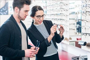 optician assisting a customer in an optometry office