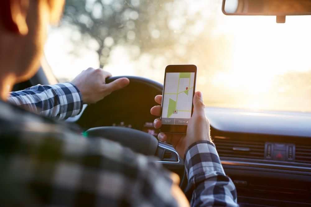 Man looking at navigation app during commute to work