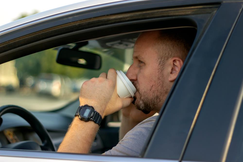 Man drinking coffee on his way to work