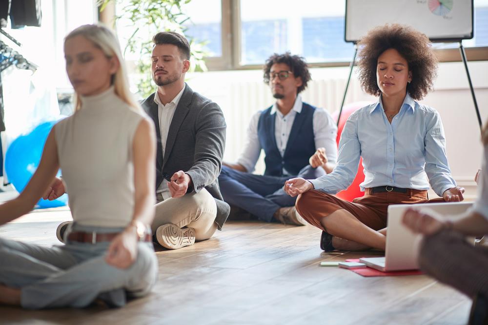 employees meditating together at work