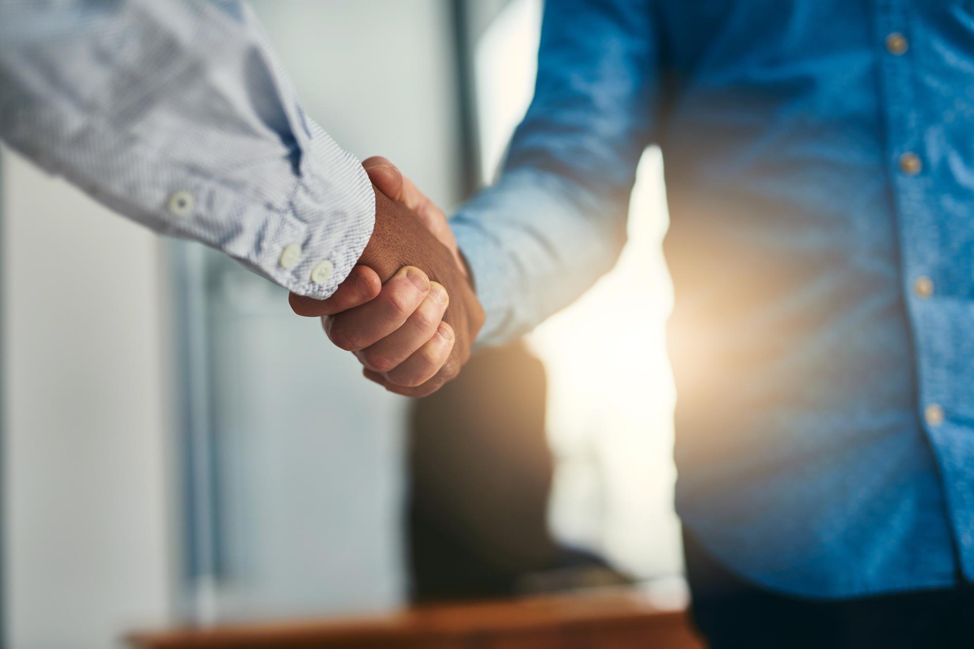 two men shaking hands in agreement