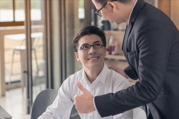 Boss saying good job to employee