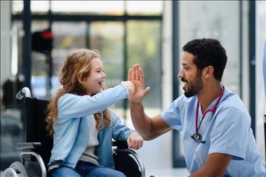nurse giving his young patient a high five