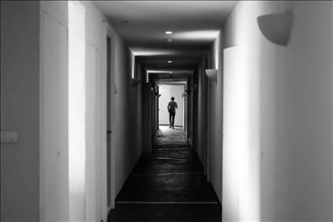 Ghostly apparition at the end of a long hallway