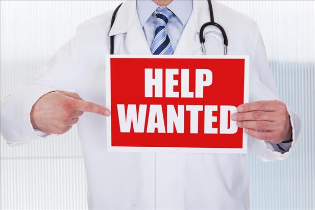 Doctor holding help wanted sign