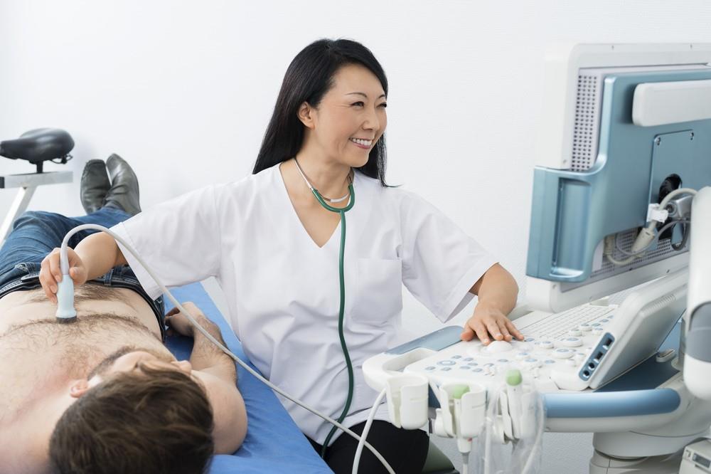 diagnostic medical sonographer performing an ultrasound exam on a patient