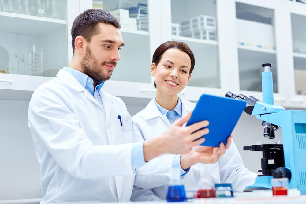 two medical technicians working together in a lab