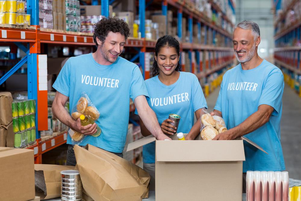 group of volunteers stocking warehouse shelves