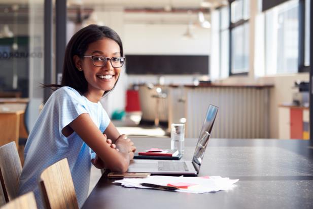 women in front of laptop smiling