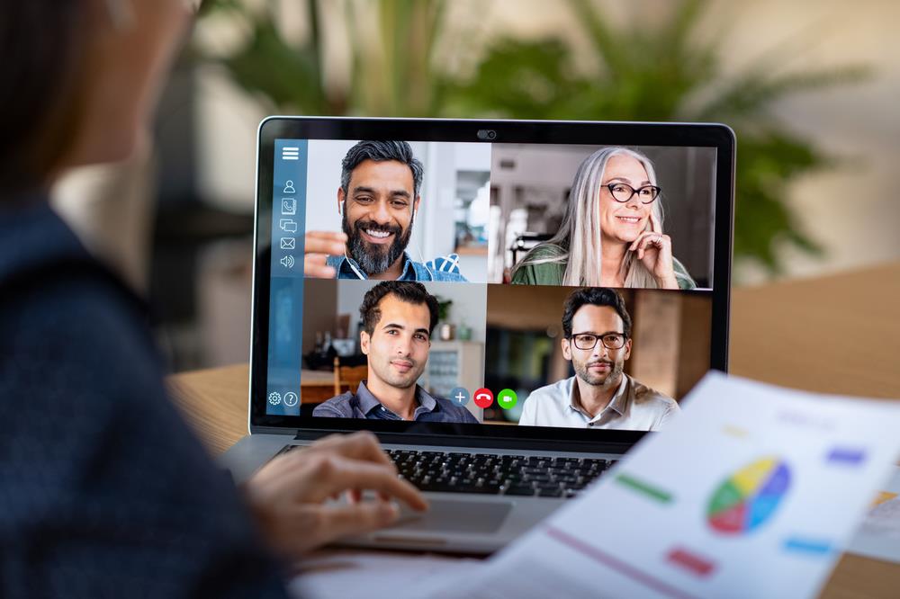 remote worker having a conference video call with four other associates