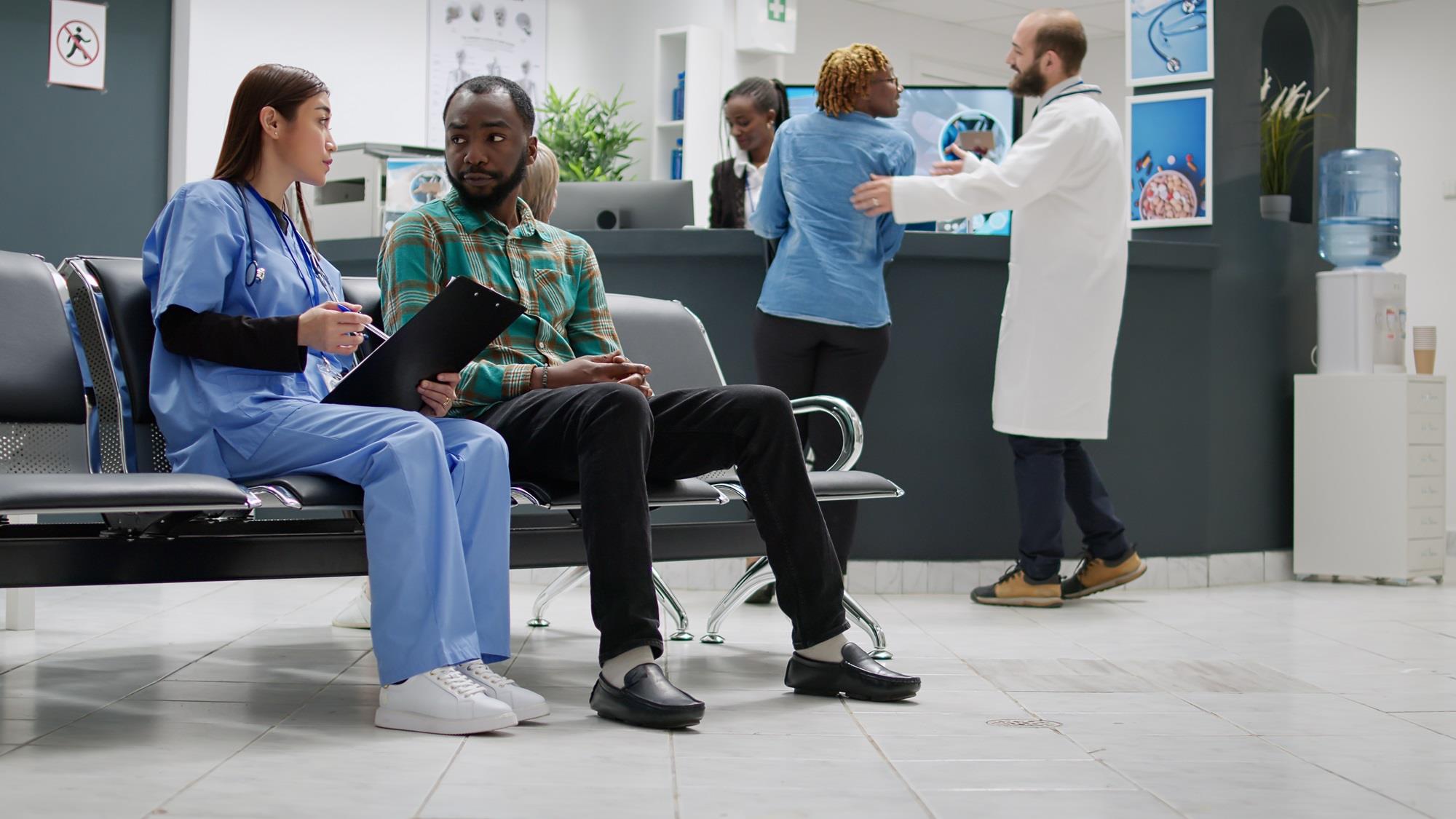 nurse meeting with a patient in a hospital waiting room