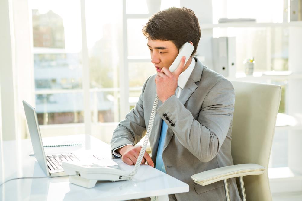 Professional at his desk talking on the phone