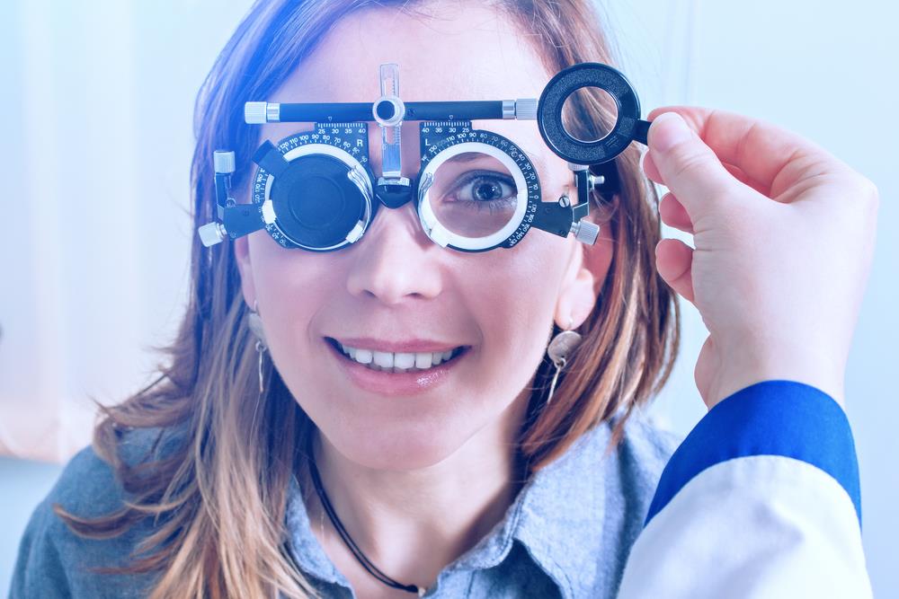 woman in messbrille glasses being tested by an orthoptist