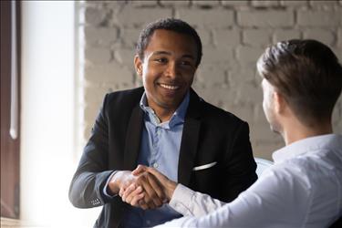 employee shaking hand with new boss