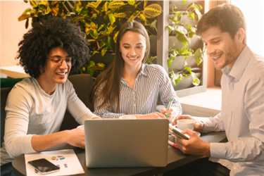 three young employees looking at computer