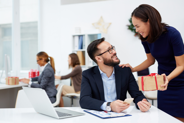 employee giving colleague a gift