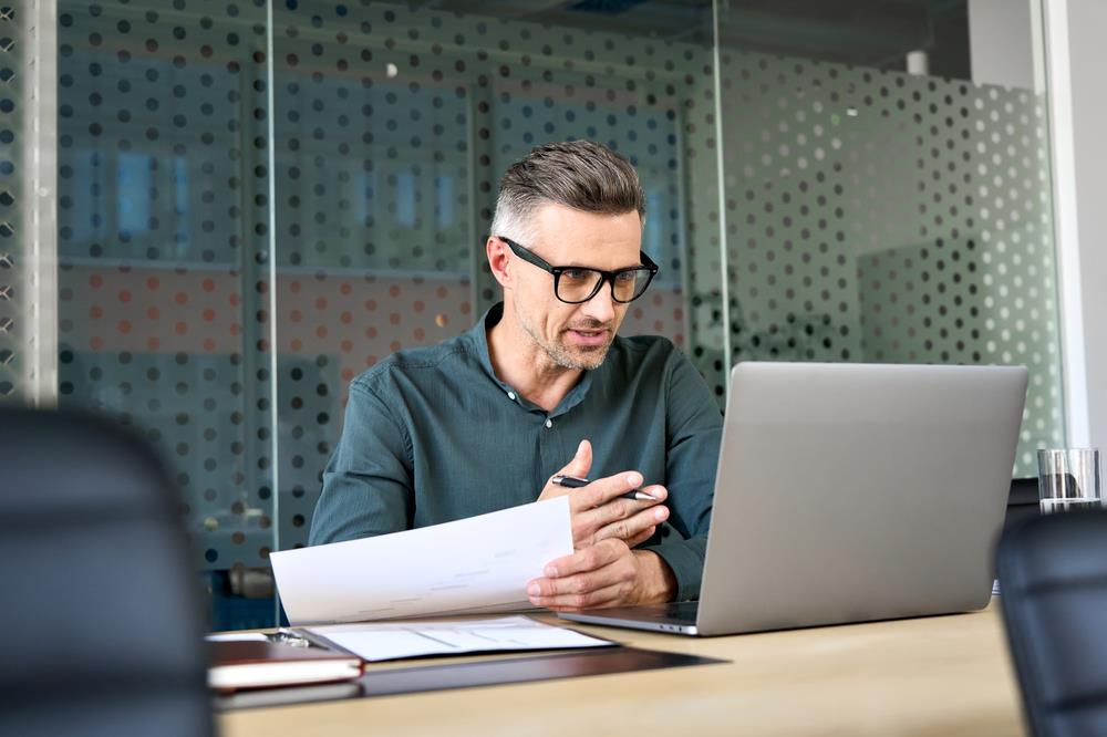 mature job seeker working on his laptop