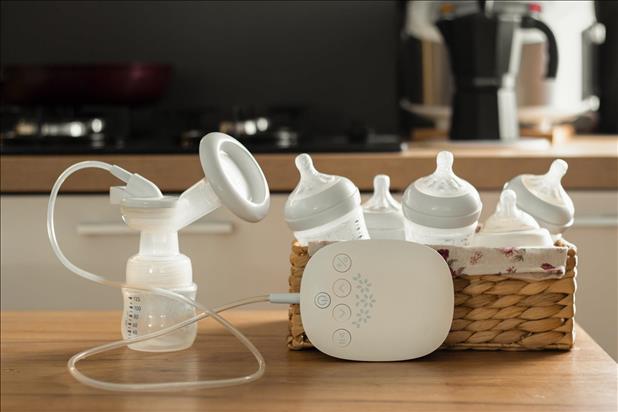 electric breast pump and bottles sitting on a table