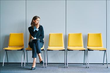 job seeker waiting nervously in the reception area for her interview to begin