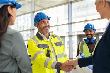 construction worker shaking hands with their manager